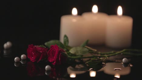 romantic background with red roses and candles, erotic mood concept with selective focus and no people