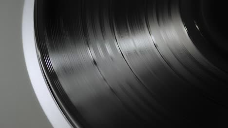 close up of a silver modern vinyl spinning on a turntable