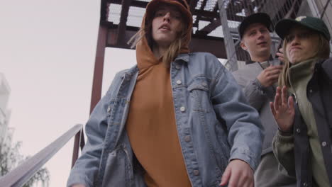 Young-friends-listening-to-music-on-the-stairs