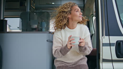 tranquil tourist sitting campsite stairs with tea cup close up. woman drinking