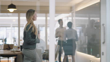 beautiful-business-woman-using-smartphone-walking-through-office-texting-sending-emails-successful-female-executive-checking-messages-on-mobile-phone-arriving-at-busy-workplace-4k