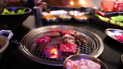 beef and bacon grilling on a restaurant grill