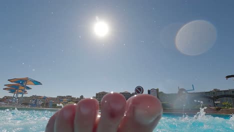 point of view riding down an slide in a water park