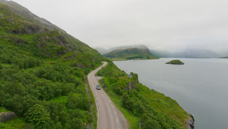 vehicle driving on lofoten island past the water of selfjorden