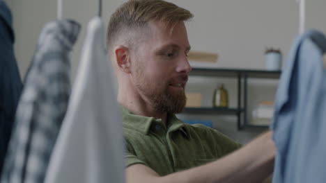 man choosing clothes from a wardrobe