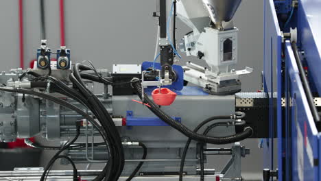 molded plastic product transferred by robotic arm of an injection molding machine