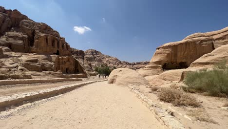 Petra-valley-in-Wadi-Musa,-Jordan-with-The-Treasury-in-the-middle-of-a-rocky-and-mountainous-landscape,-an-UNESCO-heritage-site,-ancient-Nabatean-Kingdom-4K-Establish-Shot