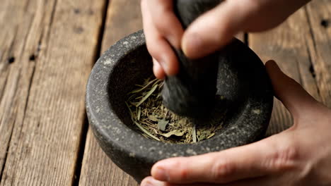 grinding herbs with mortar and pestle