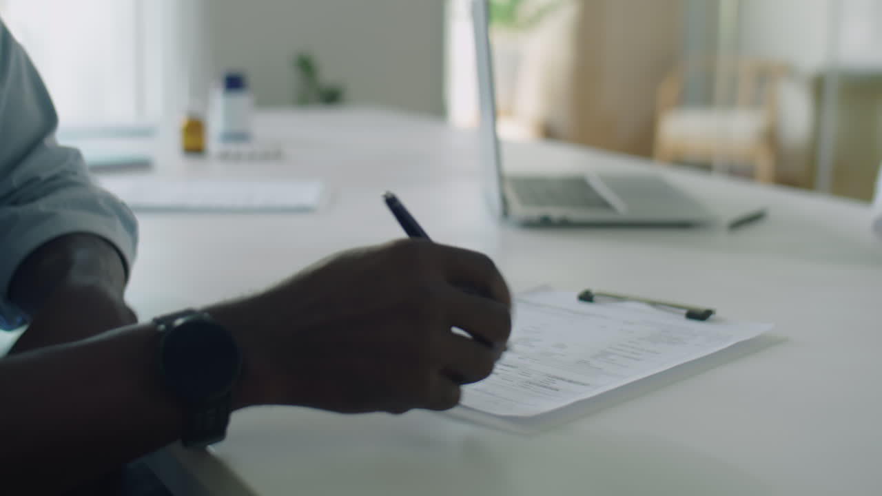Patient Signing Medical Agreement and Shaking Hands with Doctor