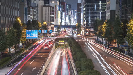 timelapse of traffic at night with cityscape buildings from yurikamome shimbashi station connecting passage in higashishinbashi, minato city, tokyo, japan