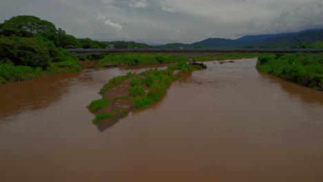 Aerial-view-of-the-Tarcoles-River-and-a-crossing-bridge,-Costa-Rica