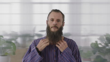 portrait of mature hippie entrepreneur man looking serious at camera confident start up businessman with funky beard