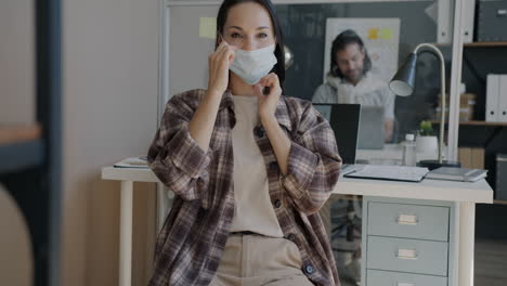 woman wearing mask in office