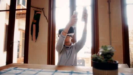 boy with virtual reality headset playing video game at home
