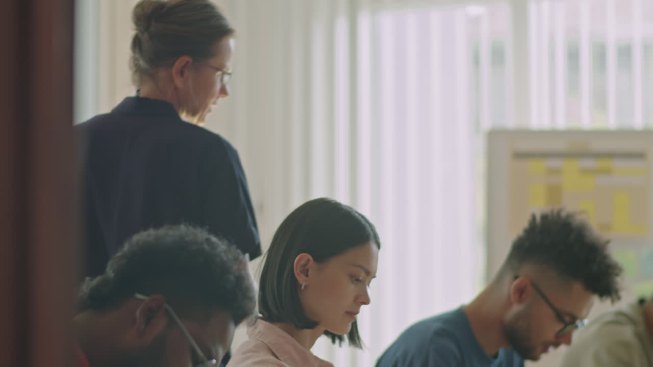 Teacher Walking Around Migrant Students during Exam