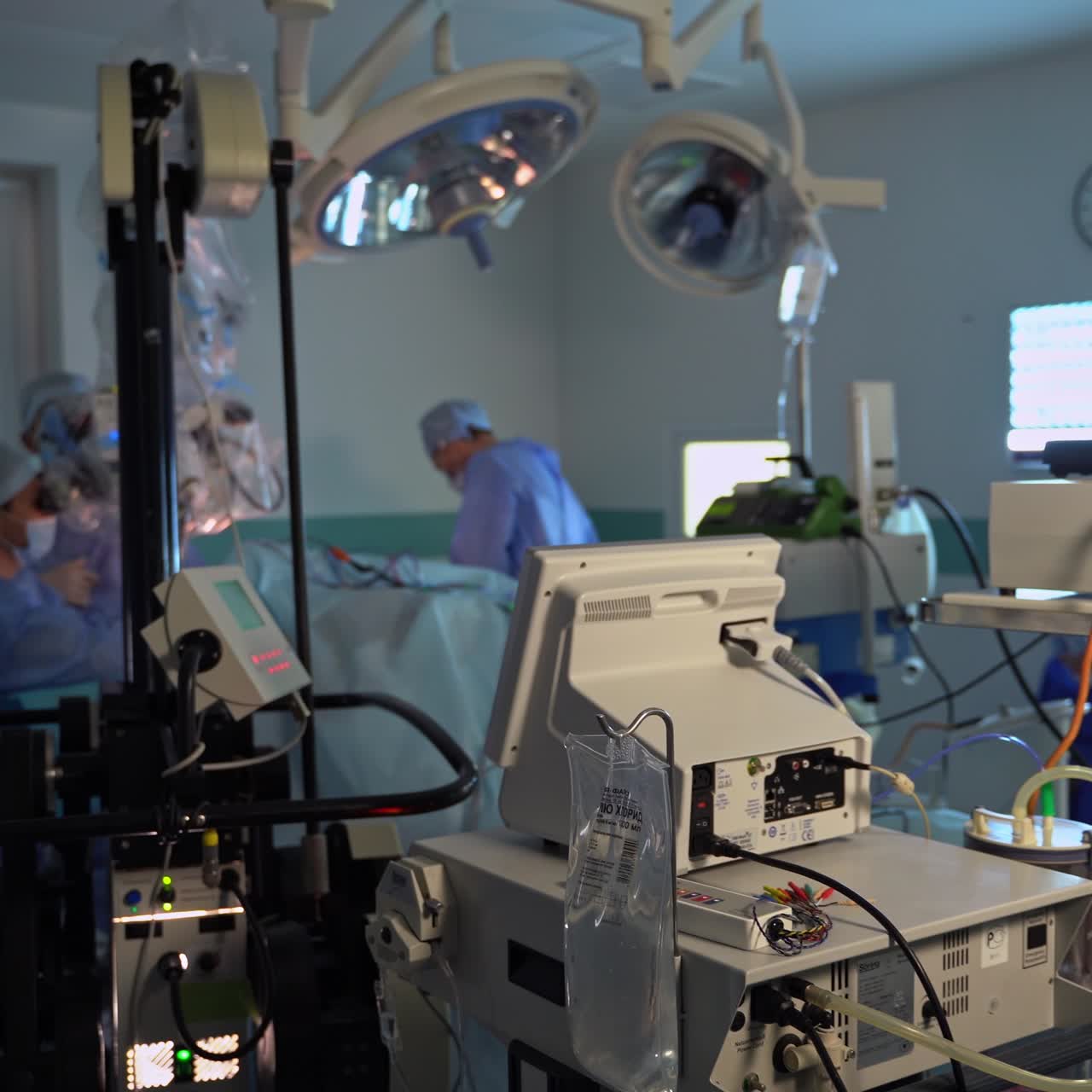 Numerous surgical equipment for operational room. Complicated medical technique for neurosurgery. Team of surgeons working at the backdrop
