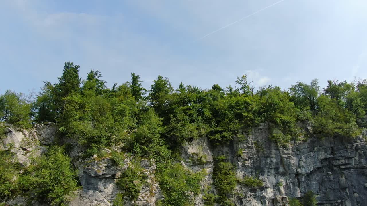 Cliff face in a valley in Rakov Skocjan national wild life park in Cerknica, Slovenia. Rising aerial reveal shot
