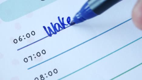 handwriting a to do list: wake up, breakfast, office