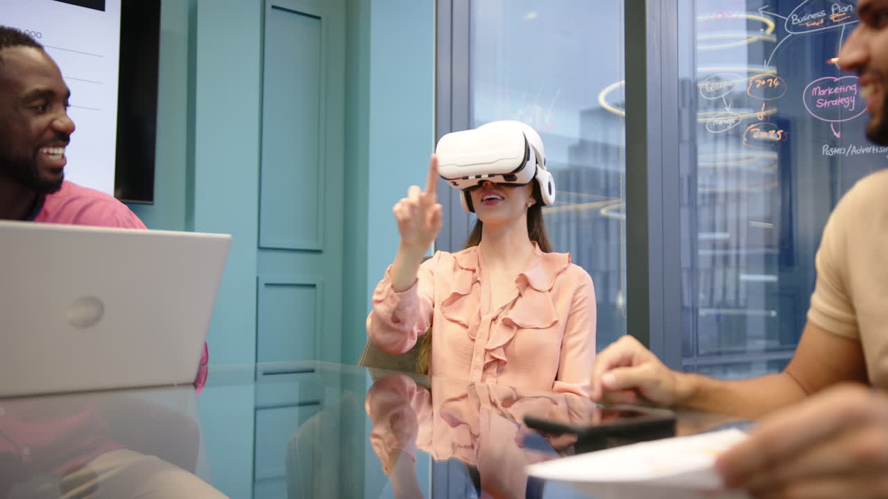 Using VR headset, woman interacting in modern office meeting with diverse colleagues
