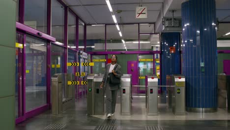 woman walking through subway station entrance