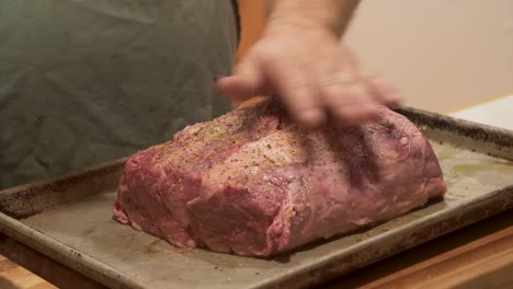 chef adds spices and seasoning to a very expensive cut of wagyu kobe beef