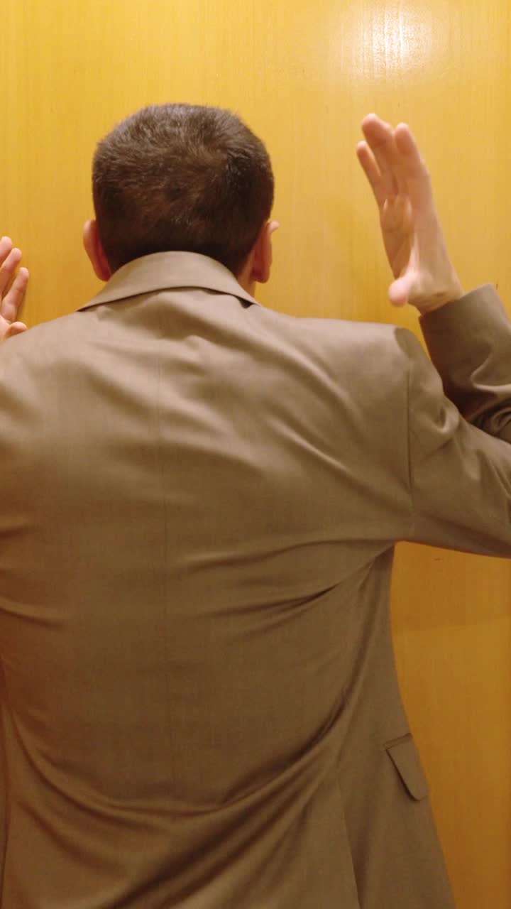Angry man waiting for wife in front of door