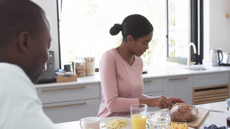 african american couple enjoys breakfast in a sunny kitchen