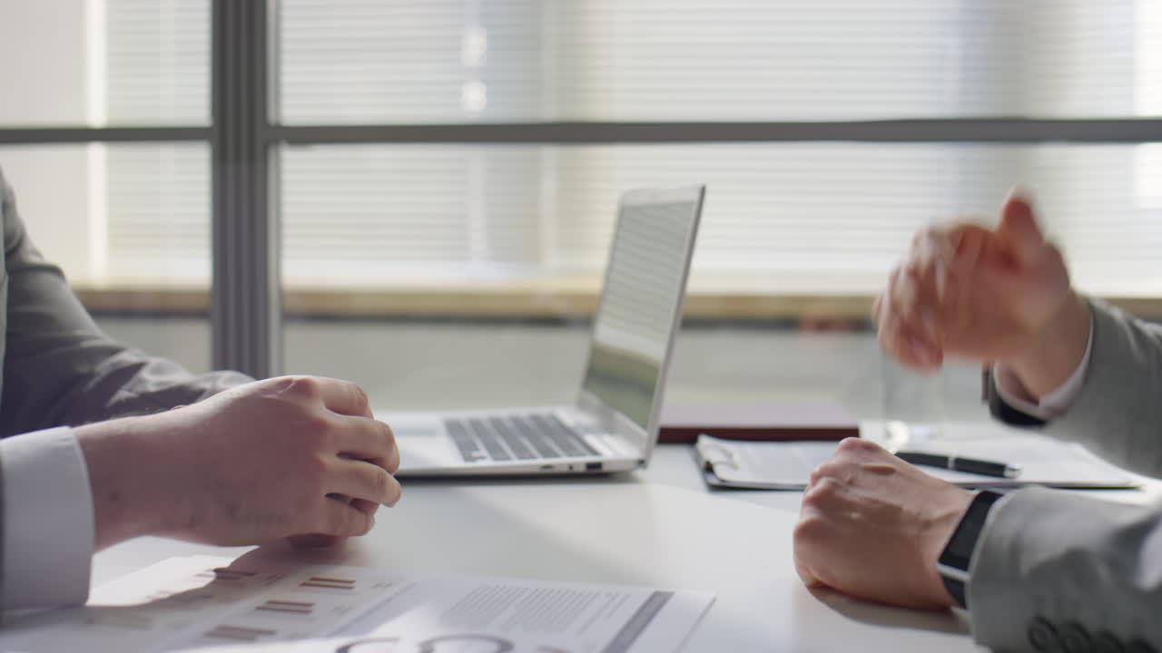 Businessmen Shaking Hands and Having Discussion in Office