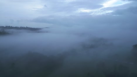 drone shot focusing on the mist and clouds that formed above the windermere lake, the largest lake in england located in the county of cumbria in great britain