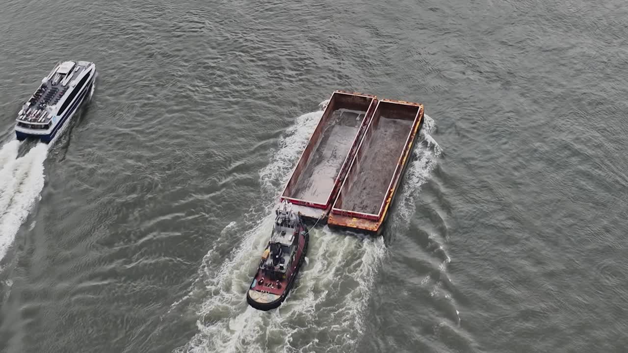 Tugboat navigating barge in New York waterways during daylight