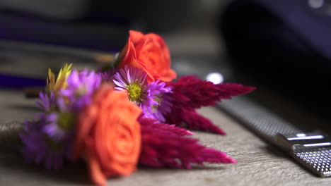 Close-up-shot-of-orange-rose-kept-in-the-table-with-blurred-background