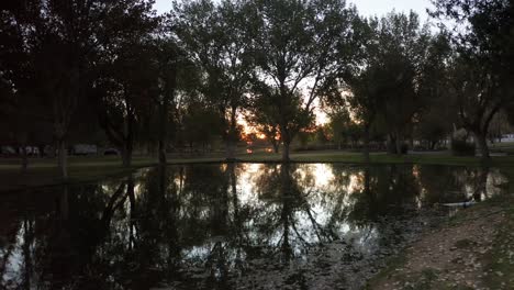 fly over park lake at sunrise