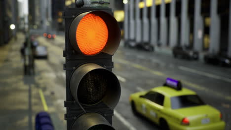 traffic signal displays red light on busy urban street in the afternoon