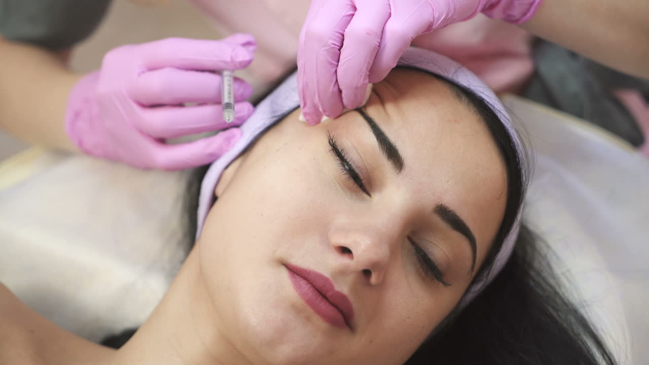 A woman on the procedure of injections in a cosmetology clinic