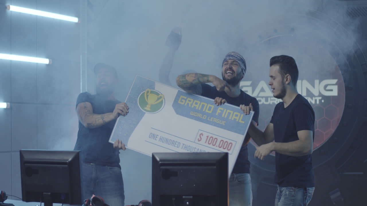 Gaming Tournament Team Celebrating their Victory Medium Shot of a Gaming Tournament Team Holding their Prize while Celebrating their Victory