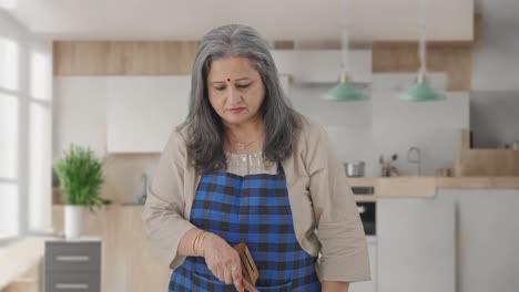 happy indian aged housewife cooking food