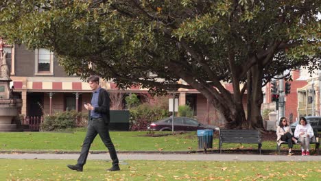 man walking past people and a dog