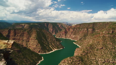 boats sailing over turquoise lake reservoir through majestic canyons