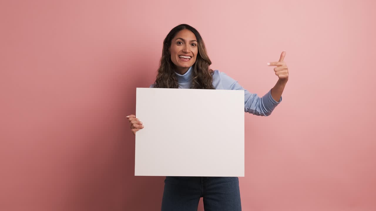 Woman holding a blank panel and pointing around