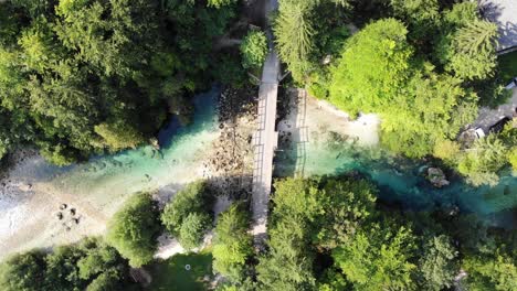 amazing view from above of a turquoise river with footbridge near bohinj lake in slovenia