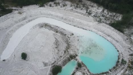 stretch of white sand mines seen from above and form a small river around it