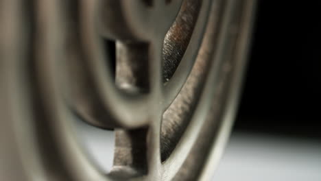 white candles burning in a silver menorah standing at an angle to camera, selective focus on centre of candelabrum, close up, tilt shot