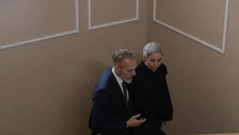elderly couple walking upstairs