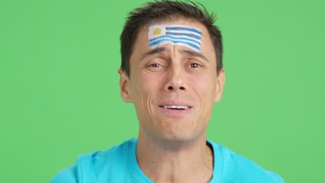 very nervous man supporting uruguayan team during a difficult match