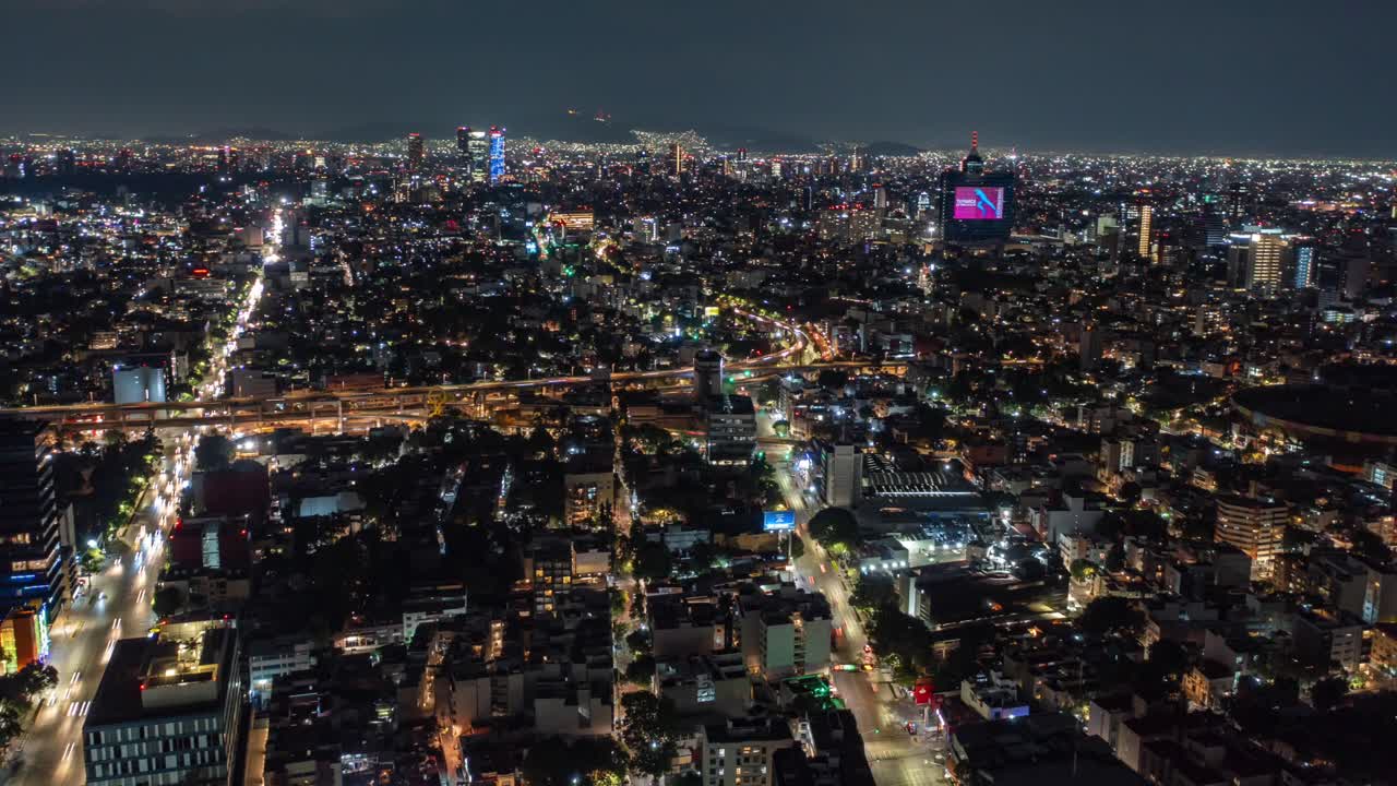 Aerial Hyperlapse view above traffic WTC at night, in Mexico city, America - time lapse, drone shot nocturnal Mixcoac, CDMX