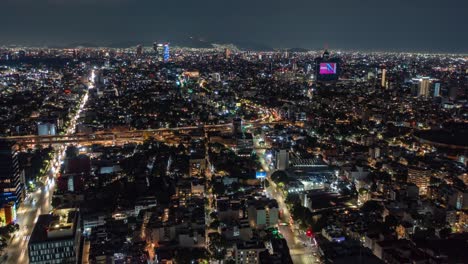 aerial hyperlapse view above traffic wtc at night, in mexico city, america - time lapse, drone shot nocturnal mixcoac, cdmx