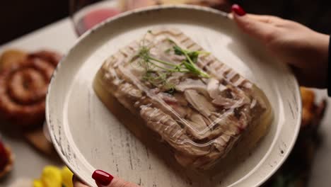 woman serving a plate of aspic