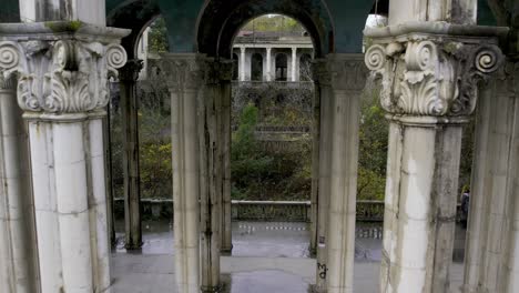 Drone-pulls-out-of-between-tight-pillars-in-Medea-sanatorium-in-Tskaltubo-Georgia-Imereti-region