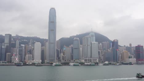 ship moves in front of hong kong skyscrapers and victoria harbour