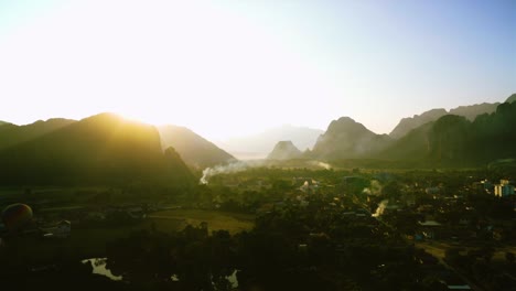 bird's eye view of picturesque dramatic sunrise in mountain landscape from the rural city of vang vieng, laos